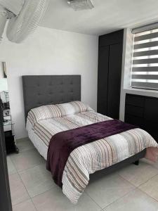 um quarto com uma cama e uma janela em Alojamiento completo, con una excelente ubicación em Guadalajara