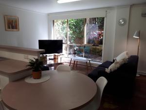 a living room with a table and a couch at Roshnier Apartment in Warrnambool