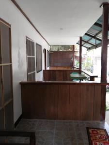 a kitchen with wooden cabinets and a counter top at Bundal Riverside Room #3 in San Vicente