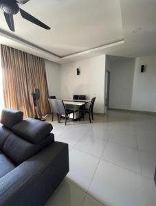 a living room with a couch and a table at MR 16 Homestay Putrajaya Dwiputra in Putrajaya