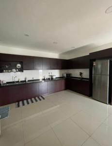 a large kitchen with a stainless steel refrigerator at MR 16 Homestay Putrajaya Dwiputra in Putrajaya
