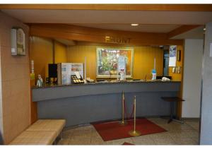 a front desk of a store with a sign that reads front at Hotel Hachiman in Hachiman