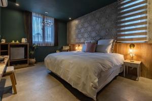 Postel nebo postele na pokoji v ubytování 茉白電梯民宿Bed and Breakfast Elevator 花蓮夜市電梯包棟