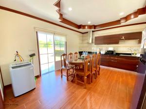 a kitchen with a table and chairs in a room at Sand-D House Pool villa B30 at Rock Garden Beach Resort Rayong in Mae Pim +10 photos