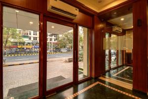 a room with windows and a view of a street at SRTC Hotel Aspire in Ahmedabad