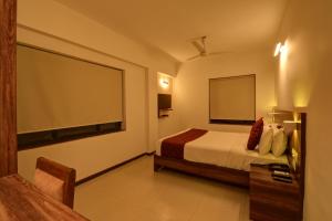 Tempat tidur dalam kamar di SRTC Hotel Aspire