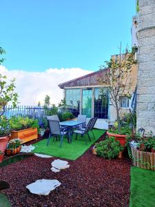 a patio with a table and chairs in a yard at Charming Luxury Room 10 Min from the Old City in Jerusalem