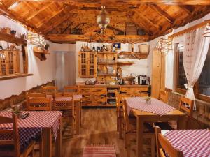 a kitchen with wooden tables and a kitchenasteryasteryasteryasteryasteryasteryasteryastery at Plitvice Green Valley in Plitvička Jezera