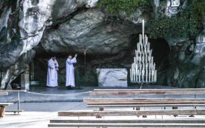 deux prêtres debout sur une scène devant une grotte dans l'établissement Family Saint Vincent 4 pers gare lourdes wifi, à Lourdes