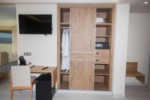a room with a desk and a sliding door at Hotel Boutique O Náutico Laxe in Laxe