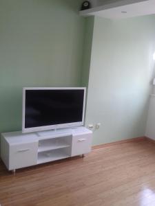 a flat screen tv sitting on top of a white entertainment center at Apartment Mery in Trogir