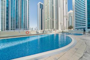 a swimming pool in a city with tall buildings at HiGuests - Spacious Apartment next to Dubai Harbour & Marina in Dubai