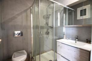 a bathroom with a shower and a toilet and a sink at Gravity Downtown Scandi Studio in Rhodes Town
