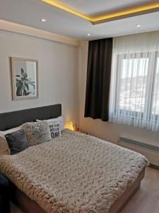 a bedroom with a large bed with a sign on it at Šilja Kopaonik S45 Milmari in Kopaonik +46 photos