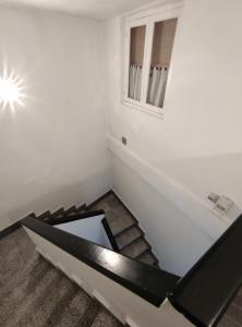 a room with a staircase with a window at Apt VILLA CUDILLERO recep P Isabel in Cudillero