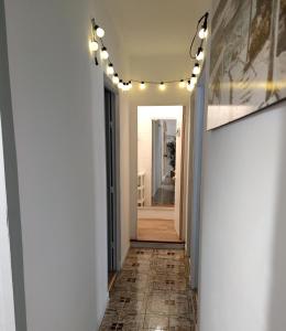a hallway with white walls and a hallway with lights at Apt VILLA CUDILLERO recep P Isabel in Cudillero