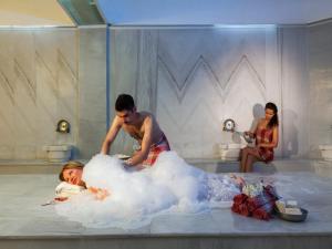 a man in a bath tub with a woman in a wedding dress at Lykia Botanika Beach Fun & Club - All Inclusive in Fethiye