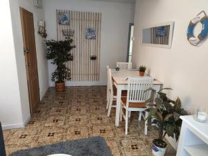 a dining room with a table and a table and chairs at Apt VILLA CUDILLERO in Cudillero