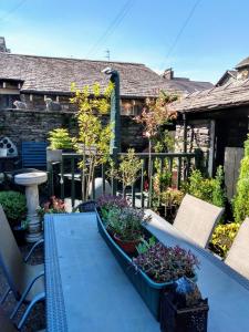 a patio with potted plants and a house at The Lakes B and B in Ambleside