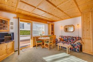 a living room with a couch and a table at Apartments Olympiastraße in Seefeld in Tirol