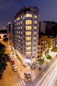 a tall building with a street in front of it at Calista Sai Gon Hotel in Ho Chi Minh City