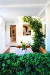 a living room with a table and some plants at Apartment Marinero with FREE parking in Dubrovnik