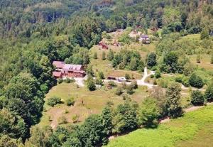 an aerial view of a house on a hill with trees at Osada Jelonki Wielka Puszcza in Porąbka