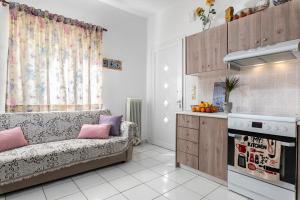 a living room with a couch and a kitchen at Blossom in Ierapetra