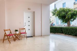 two chairs and a table in front of a door at Blossom in Ierapetra