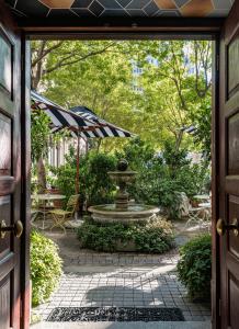 a courtyard with a fountain and an umbrella at Labotessa Boutique Hotel in Cape Town