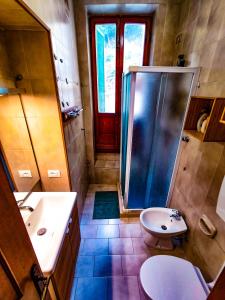 a bathroom with a shower and a sink and a toilet at Appartamento La Marineria in Rio Marina