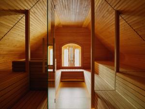a sauna with a window in a wooden cabin at Wilmina Hotel in Berlin