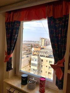a window with a view of a city at Apartament Ultraconfort in Iaşi