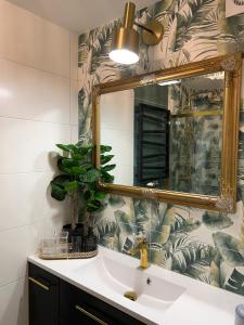 a bathroom with a sink and a mirror at Comfort Zone Ostróda Villa Apartment Duplex in Ostróda