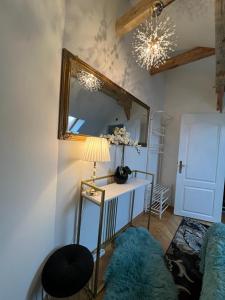 a room with a mirror and a table with a lamp at Comfort Zone Ostróda Villa Apartment Duplex in Ostróda