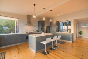 a kitchen with a large island in the middle of a room at Constantia Views Villa Wilderness in Wilderness