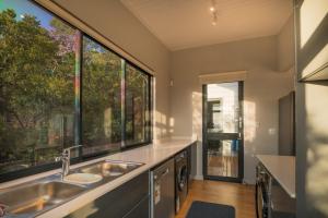 a kitchen with a sink and a large window at Constantia Views Villa Wilderness in Wilderness