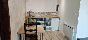 a small kitchen with a counter and a sink at Studio Les Cadichons de la Grange in Saint-Péray