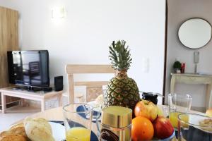 stół z ananasem i talerzem owoców w obiekcie Tupi Nest w Alvor