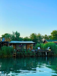 a house on a dock next to a body of water at Zen House for 2 in Ulcinj