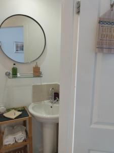 a bathroom with a sink and a mirror at The Lakes B and B in Ambleside +137 photos