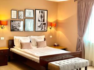 a bedroom with a large bed and a painting on the wall at Pensiunea Marylou in Alba Iulia