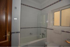 a bathroom with a shower and a tub and a toilet at Bugibba Square Seaview 3 Bedroom Apartment in St. Paul's Bay