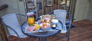 a table with a tray of breakfast food on it at Acacia Cottage in Maun