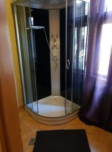 a shower with a glass enclosure in a bathroom at Bableves Vendégház in Felsőtold