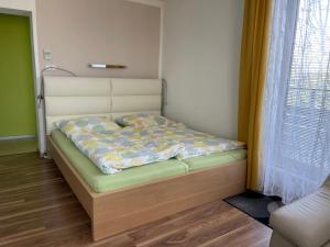 a small bed in a room with a bed frame at Apartment Jan in Prague