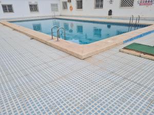 a swimming pool with blue water in a building at Hany apartment Ducado 2-I in Benidorm