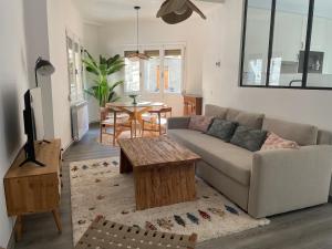 a living room with a couch and a table at CHECK-IN CASAS Casa Aurora in Benasque