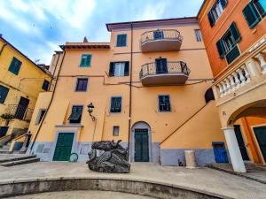 a building with a statue in front of it at Appartamento La Marineria in Rio Marina +9 photos