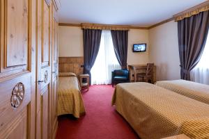 Postel nebo postele na pokoji v ubytování Hotel Crampon